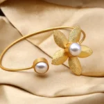 Golden Pearl Floral Open Bracelet with textured flower design