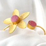 Golden floral open bracelet with pink stone detailing