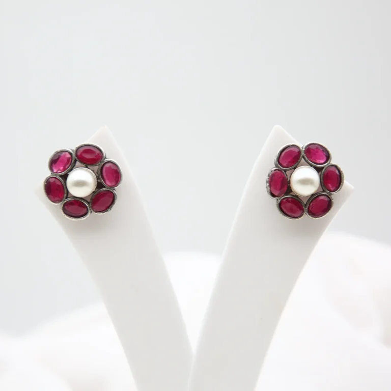 Ruby pearl floral stud earrings with antique silver finish and Monalisa stones